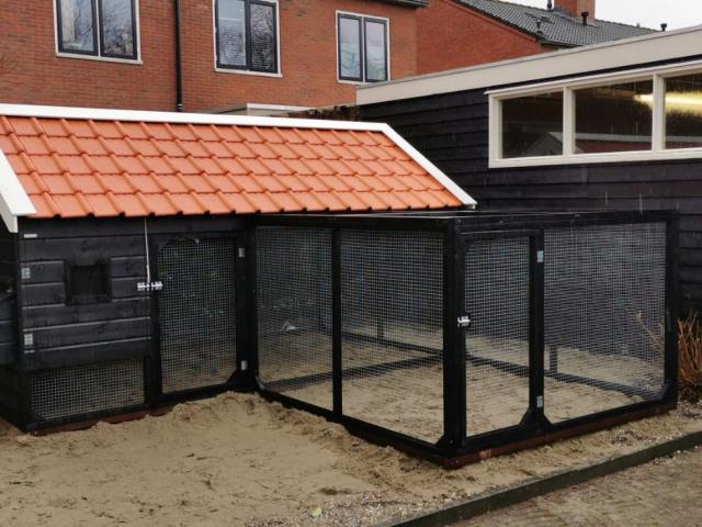 Dierenverblijven van der land Grote kippenhok met dakpannen en grote ren.